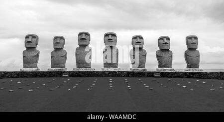 A black and white landscape photo of the seven Easter Island replica Moai statues at Sun Messe Nichinan in Miyazaki Prefecture, Kyushu, Japan Stock Photo