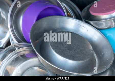 A close up view of metal and plastic dogs bowls all in a pile Stock Photo