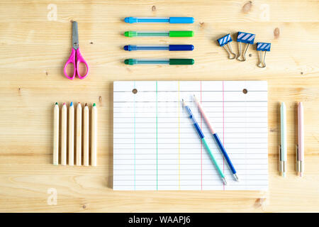 Top view of paper, some clips, pencils, highlighters, pens and scissors Stock Photo