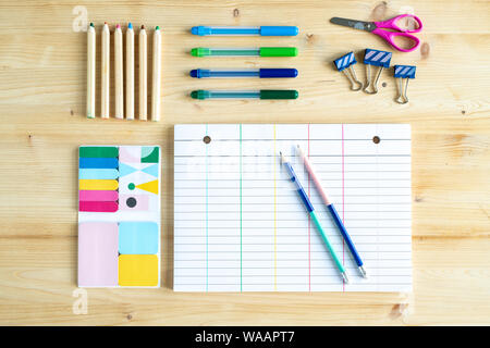 Top view of sheet of paper with lines surrounded by group of office supplies Stock Photo