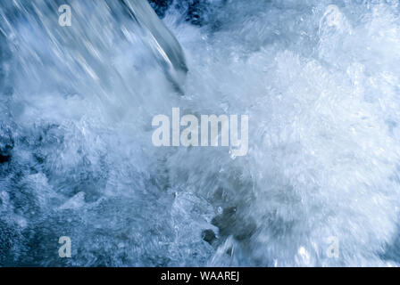 abstract background - a small but turbulent water stream in foam and jets Stock Photo