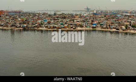 Slum area near port in Manila, Phillippines, top view. lot of garbage in the water. Stock Photo