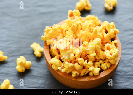 Sweet butter popcorn in bowl on dark plate backgroud Stock Photo