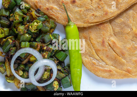 Lachha Paratha, whole wheat layered flat bread with Masala Bhindi (Lady finger) sabzi or Bhaji or recipe. Stock Photo