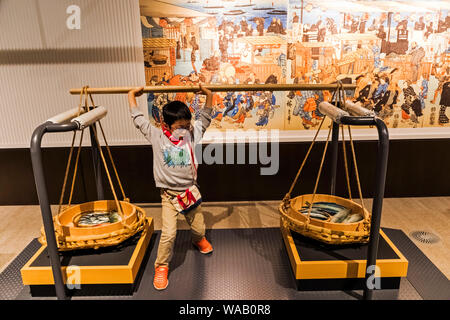 Japan, Honshu, Tokyo, Ryogoku, Tokyo Metropolitan Edo-Tokyo Museum, Young Visitor Posing with Traditional Carrying Baskets, 30076394 Stock Photo