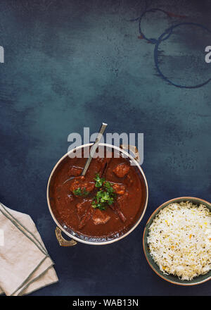 Rogan Josh lamb curry, authentic kashmiri lamb meat curry, served with pulao rice and garnished with coriander, top view Stock Photo