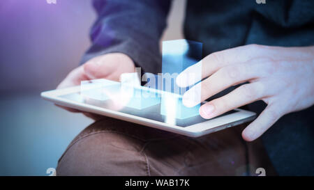 businessman interacts with hologram chart on a tablet Stock Photo