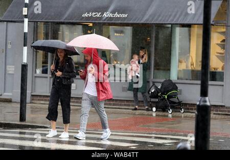 Pic shows: August washout continues as heavy rain and thunder hit Central London in Clerkenwell today.19.8.19  Shelter for woman and baby     pic by G Stock Photo