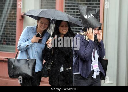 Pic shows: August washout continues as heavy rain and thunder hit Central London in Clerkenwell today.19.8.19  Bag on the head caught out with no umbr Stock Photo