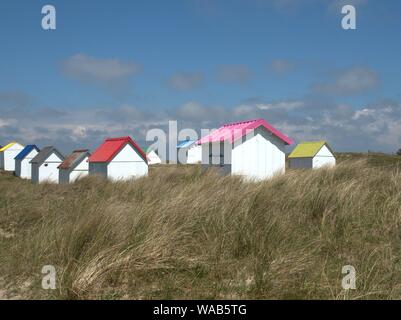 Gouville-sur-Mer, France, 24.05.2019: Beach cabins (Cabanes or Cabines de plage) with colourful roofs on the beach. | usage worldwide Stock Photo