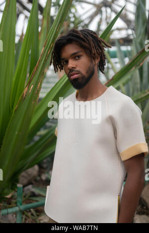 Young model promoting clothing posing in greenhouse Stock Photo