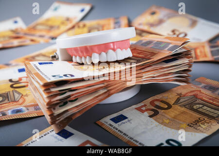 greedy people and materialism concept. mouth full of money Stock Photo