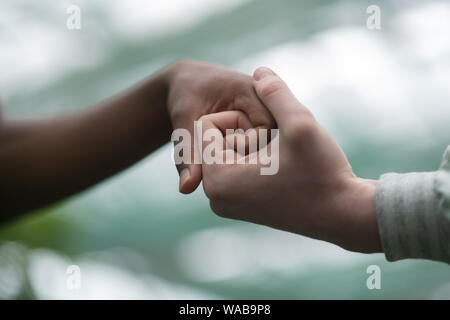Close up of men crossing their fingers together Stock Photo