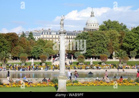 PARIS, FRANCE - JULY 23, 2011: Tourists visit Luxembourg Gardens in Paris, France. Paris is the most visited city in the world with 15.6 million inter Stock Photo