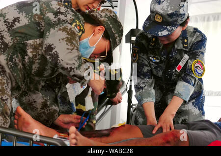 (190819) -- VIENTIANE, Aug. 19, 2019 (Xinhua) -- Participants take part in the drills during the 'Peace Train-2019' China-Laos humanitarian and medical joint rescue exercise in  Vientiane, capital of Laos, Aug. 18, 2019. (Xinhua/Zhang Jianhua) Stock Photo