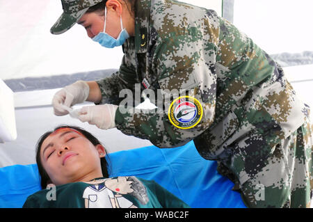 (190819) -- VIENTIANE, Aug. 19, 2019 (Xinhua) -- Participants take part in the drills during the 'Peace Train-2019' China-Laos humanitarian and medical joint rescue exercise in  Vientiane, capital of Laos, Aug. 18, 2019. (Xinhua/Zhang Jianhua) Stock Photo