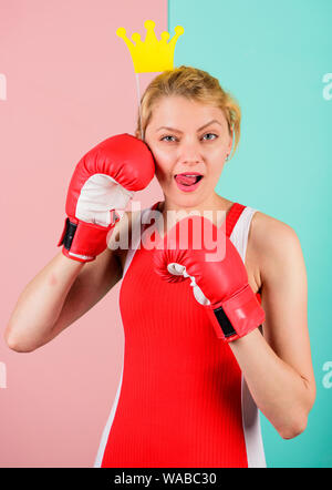 VIP gym. Woman boxing glove and crown symbol of princess. Queen of sport. Become best in boxing sport. Feminine tender blonde with queen crown wear boxing gloves. Fight for success. Fighting queen. Stock Photo