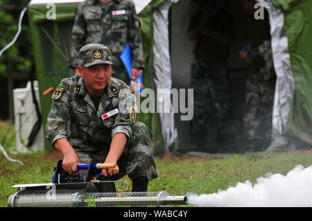 (190819) -- VIENTIANE, Aug. 19, 2019 (Xinhua) -- Participants take part in the comprehensive epidemic prevention and control drills during the 'Peace Train-2019' China-Laos humanitarian and medical joint rescue exercise in  Vientiane, capital of Laos, Aug. 18, 2019. (Xinhua/Zhang Jianhua) Stock Photo