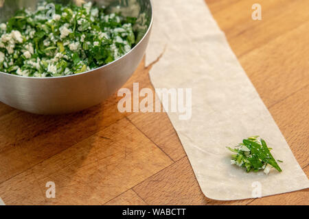 Cheese and herbs on filo dough in turkish cooking class Stock Photo