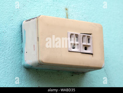 Empty electrical socket on the wall. Electricity outlet mounted at outdoor facade of house. Stock Photo
