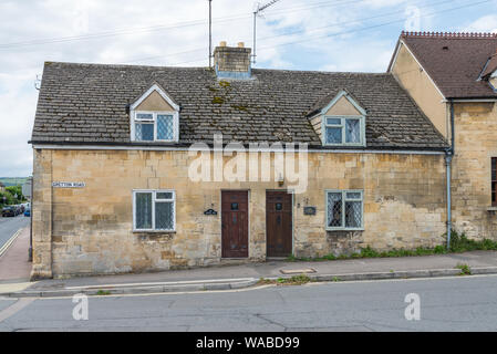 Pair of small semi-detached cottages in the pretty Cotswold town of Winchcombe, near Cheltenham, in Gloucestershire, UK Stock Photo