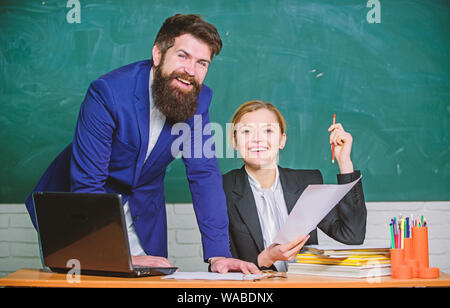 Look at this. teacher and student on exam. businessman and secretary. back to school. Non-formal education. paper work. office life. business couple use laptop and documents. Living in digital age. Stock Photo