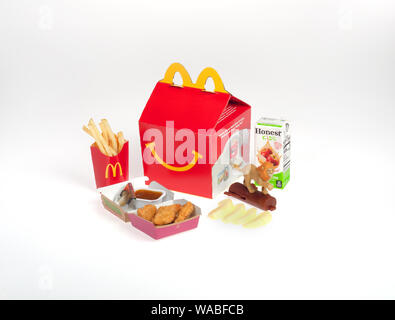 McDonald’s Happy Meal with 4 piece McNuggets, sweet & sour dipping sauce,  french fries, Honest Juice, apple slices, Lion King toy and box Stock Photo