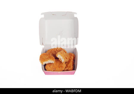 McDonald’s 6 piece chicken mcnuggets open open box showing nuggets with bites taken out Stock Photo