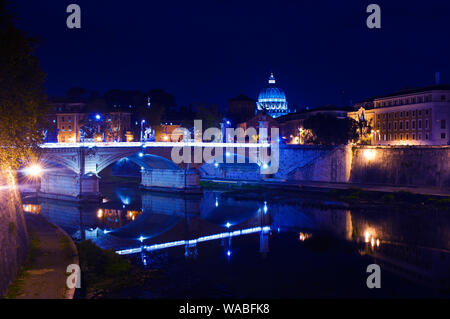 Image of Rione Ponte district. View of white Ponte Vittorio Emanuele II bridge and its reflection, orange trees, waters of Tiber river under dark blue Stock Photo