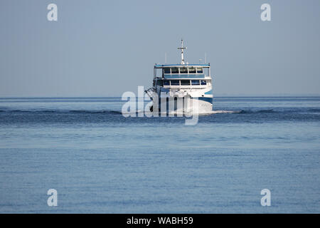Ferry moving in sea against blue sky, Rovinj, Istria, Croatia Stock Photo