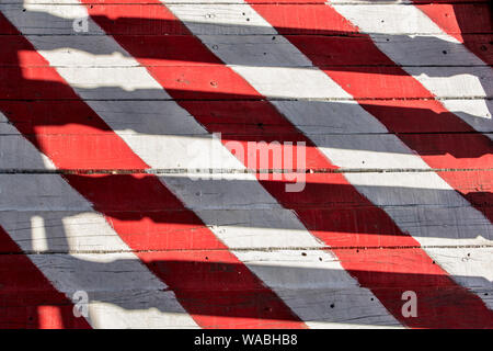 Red-white stripes on planks of footbridge. A wooden floor on the outdoor veranda. Stock Photo
