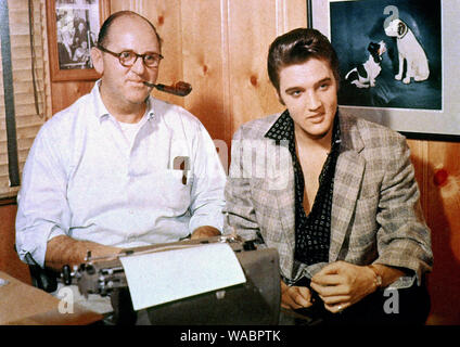 Elvis Presley with his manager, Colonel Tom Parker, signing a record contract with RCA Victor, October (1955)  File Reference # 33848-472THA