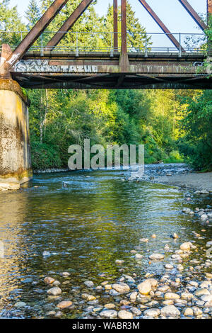 The Cedar River flows beneath a bridge in Maple Valley, Washington. Stock Photo