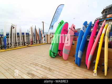 Newquay, Cornwall, UK. 16th Aug, 2019. Surfboards for Hire outside the Surf Hire shop on Newquay's famous Fistral Beach.UK's centre of Surfing is around the varied coastline and beaches of Cornwall in the very south west of the mainland. Surfers head there every summer and there are numerous, surf school, surf shops dotted around the popular Cornish towns. Credit: Keith Mayhew/SOPA Images/ZUMA Wire/Alamy Live News Stock Photo