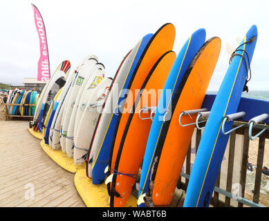 Newquay, Cornwall, UK. 16th Aug, 2019. Surfboards for Hire outside the Surf Hire shop on Newquay's famous Fistral Beach.UK's centre of Surfing is around the varied coastline and beaches of Cornwall in the very south west of the mainland. Surfers head there every summer and there are numerous, surf school, surf shops dotted around the popular Cornish towns. Credit: Keith Mayhew/SOPA Images/ZUMA Wire/Alamy Live News Stock Photo