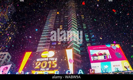 New York City, USA, January 1, 2015, Exploding party atmosphere with sky full of confetti at giant new year's eve party on famous times square interse Stock Photo