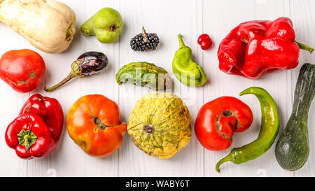 Trendy Ugly Organic Vegetables: cucumber, sweet and hot peppers, eggplant, blackberry, dogwood, pumpkin, zucchini, pear and tomatoes on white backgrou Stock Photo