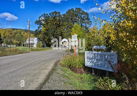 A hand made sigh for a vineyard, in front of Harris Covered Bridge, which still carries traffic, in the Willamette Valley of Oregon, east of Corvalis Stock Photo