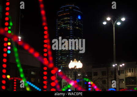 Yekaterinburg, Russia - January 17, 2019: colorful lights - a fragment of New Year's illumination outdoors in the night city and Vysotsky skyscraper o Stock Photo