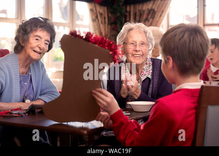Schoolchildren in the Bristol area visit care homes to make Christmas decorations with residents in a project organised by a charity Alive Activities Stock Photo