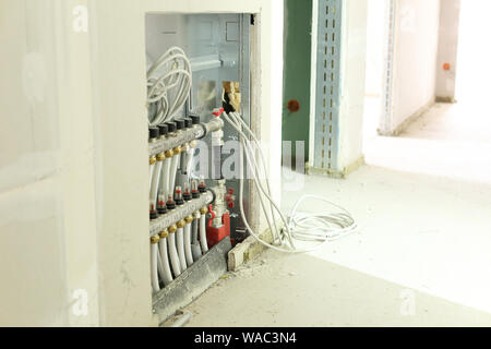 A Distributor underfloor heating on a construction site Stock Photo