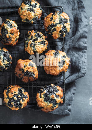 Homemade vegan blueberry muffins on dark background. Vertical. Top view or flat lay. Stock Photo