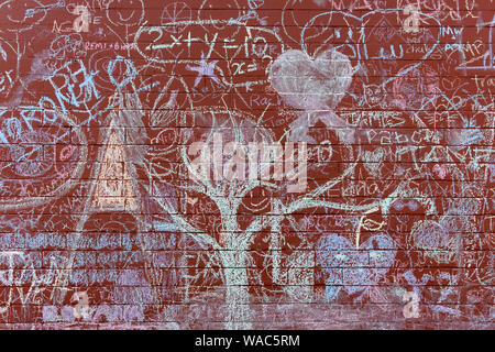 Red brick wall of a building covered in colorful chalk graffiti  in the Mount Pleasant district of Vancouver, BC, Canada Stock Photo