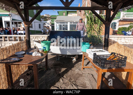 Preparing espeto de sardinas, sardine spit, Restaurante El Cabra , Pedregalejo, Malaga, Andalucia, Spain Stock Photo