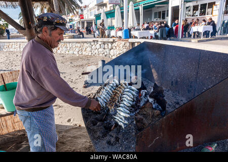 Preparing espeto de sardinas, sardine spit, Restaurante El Cabra , Pedregalejo, Malaga, Andalucia, Spain Stock Photo