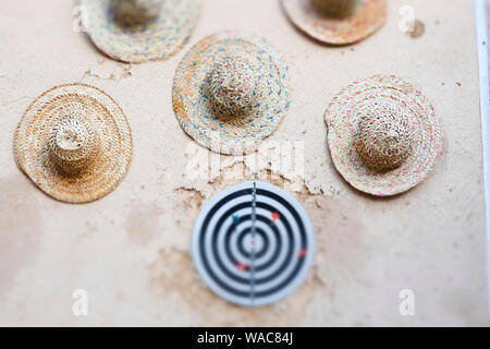 Straw hats and dartboard. Decoration detail. Yazd, Iran, Asia. Stock Photo
