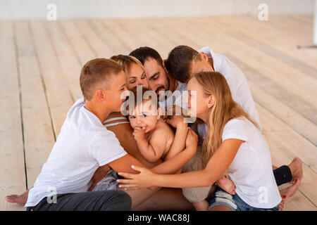 Big happy family with four kids having fun indoors. Big happy family lifestyle Stock Photo