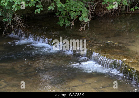 River flowing in a cascade of artificial waterfalls. Stock Photo