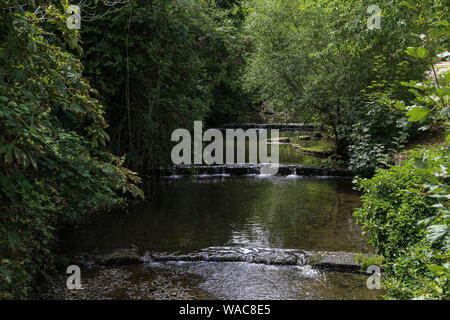 River flowing in a cascade of artificial waterfalls. Stock Photo
