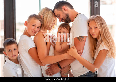 Big happy family with four kids having fun indoors. Big happy family lifestyle Stock Photo